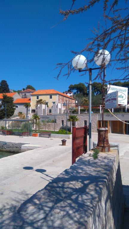a street light with two basketballs on top of a wall at Holiday Home Ana in Prvić Luka