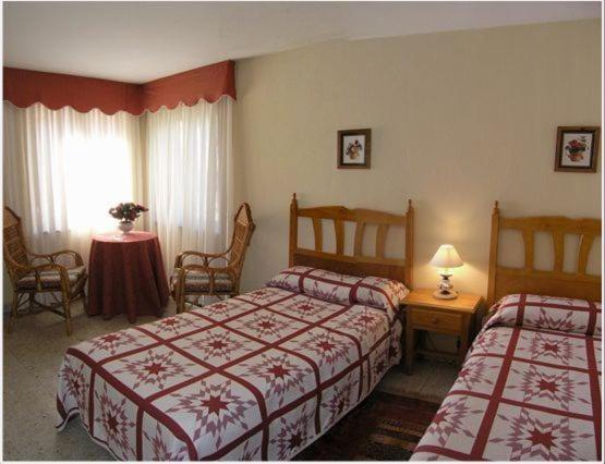 Ліжко або ліжка в номері Hostal Toscana