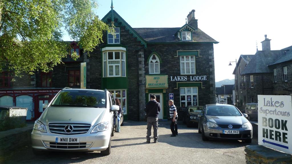 a man is standing in front of a building at Lakes Lodge Windermere in Windermere
