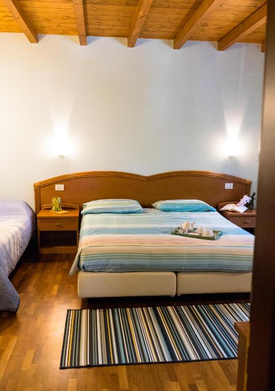 Postel nebo postele na pokoji v ubytování Agriturismo Fogolar da Capo