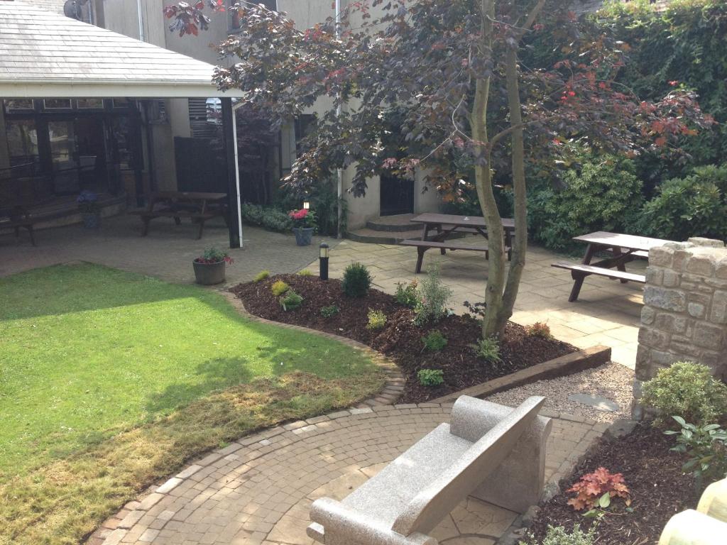 a park with a bench and a picnic table at The Royal Hotel in Cookstown