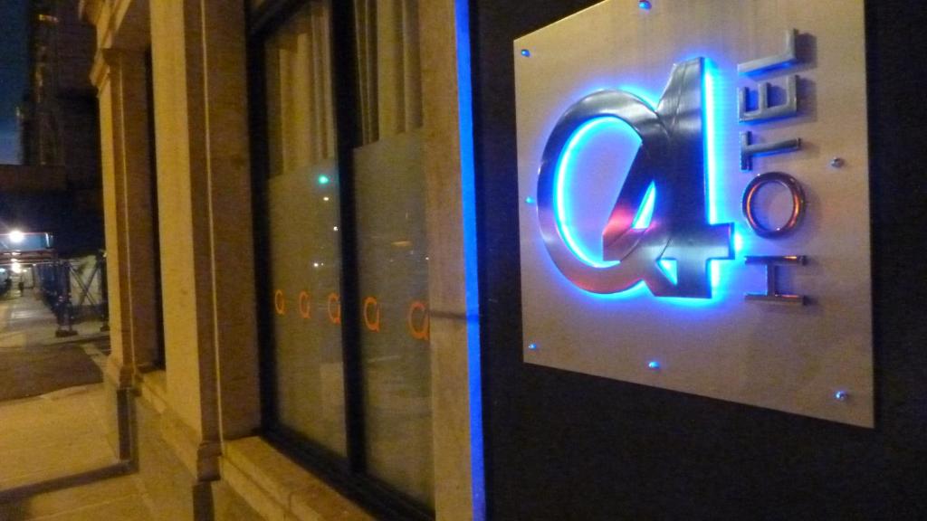 a neon sign on the door of a store at Q4 Hotel and Hostel in Queens