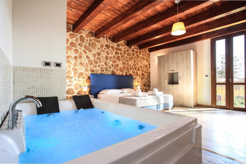 a bath room with a tub and a pool at Double B Maison De Charme in Alghero