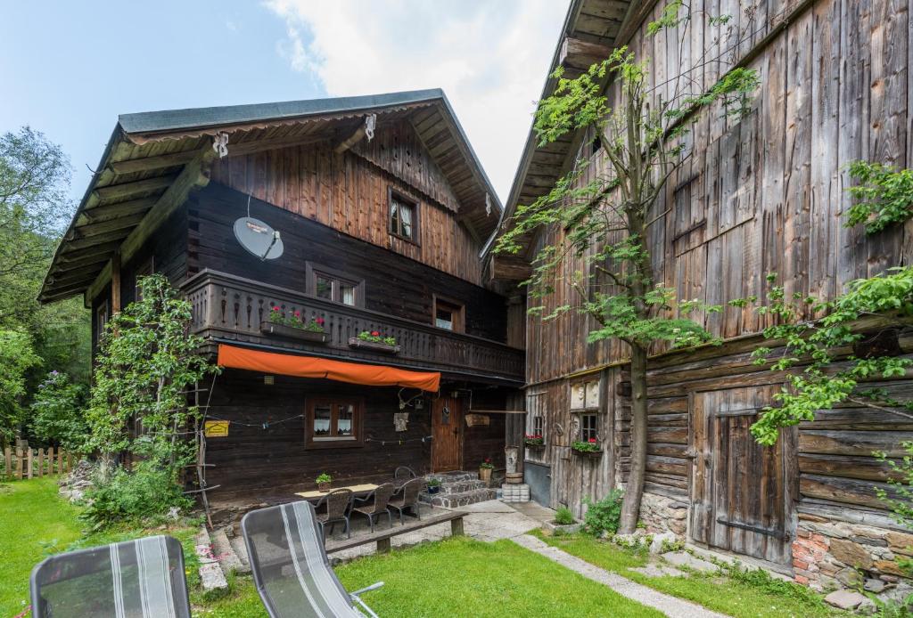 a wooden house with a slide in front of it at Almliesl LUNG-495 in Annaberg im Lammertal