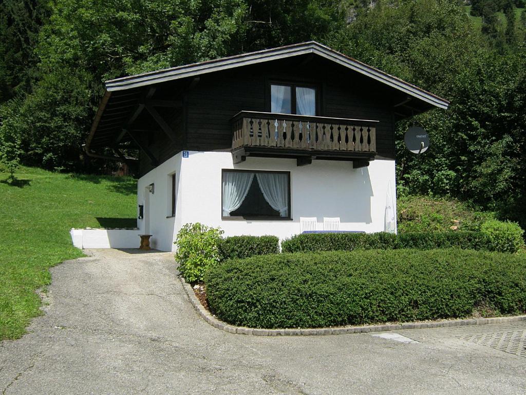 a small house with a balcony on top of it at Haus Vogel-Nest in Reit im Winkl