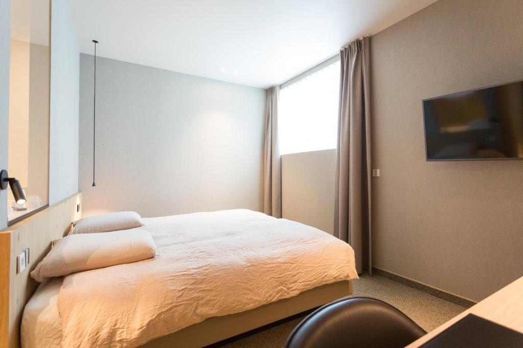 Postel nebo postele na pokoji v ubytování Hotel Den Berg