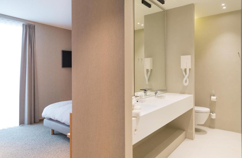 Postel nebo postele na pokoji v ubytování Hotel Den Berg
