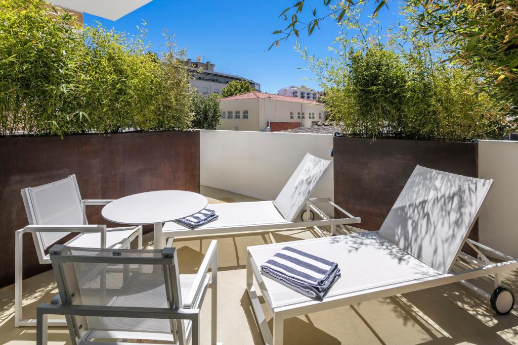 two chairs and tables on a rooftop patio at Lagos Avenida Hotel in Lagos
