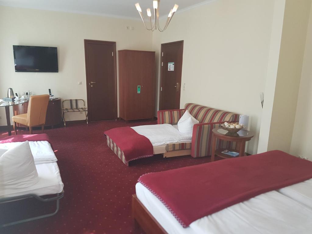 Postel nebo postele na pokoji v ubytování Hotel Arena City