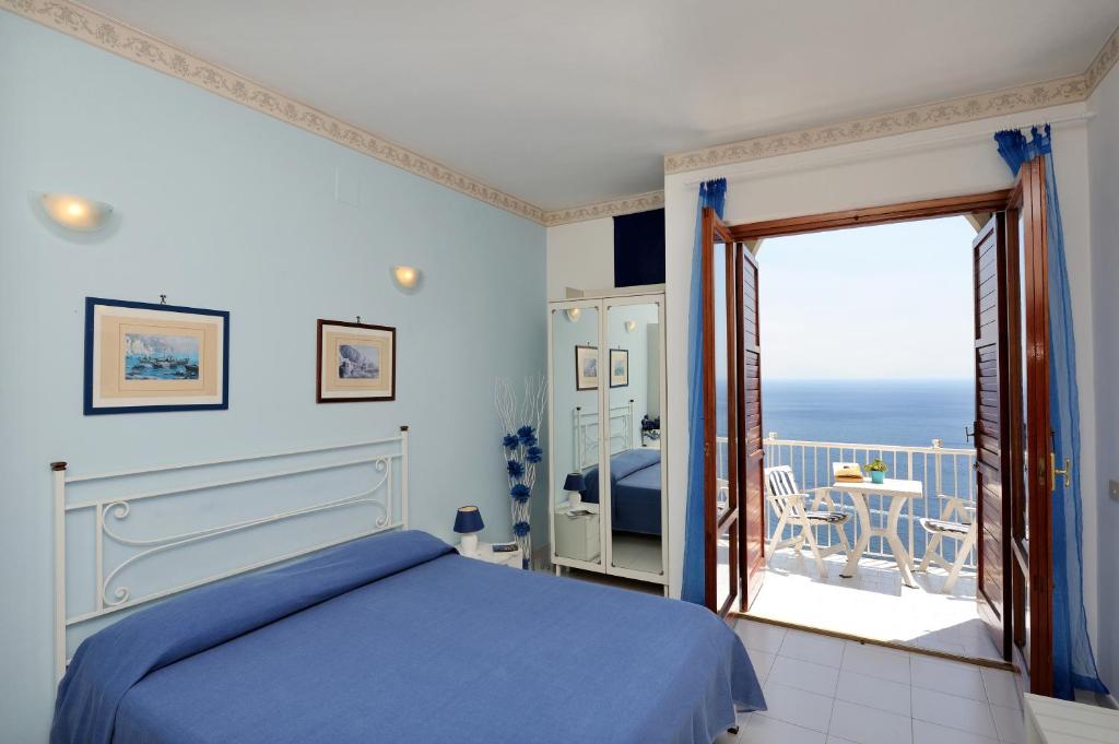 a bedroom with a bed and a view of the ocean at Casa Jole in Amalfi