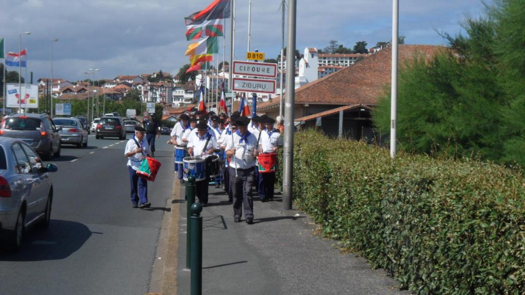 a group of people walking down a street at Toki Alai in Saint-Jean-de-Luz