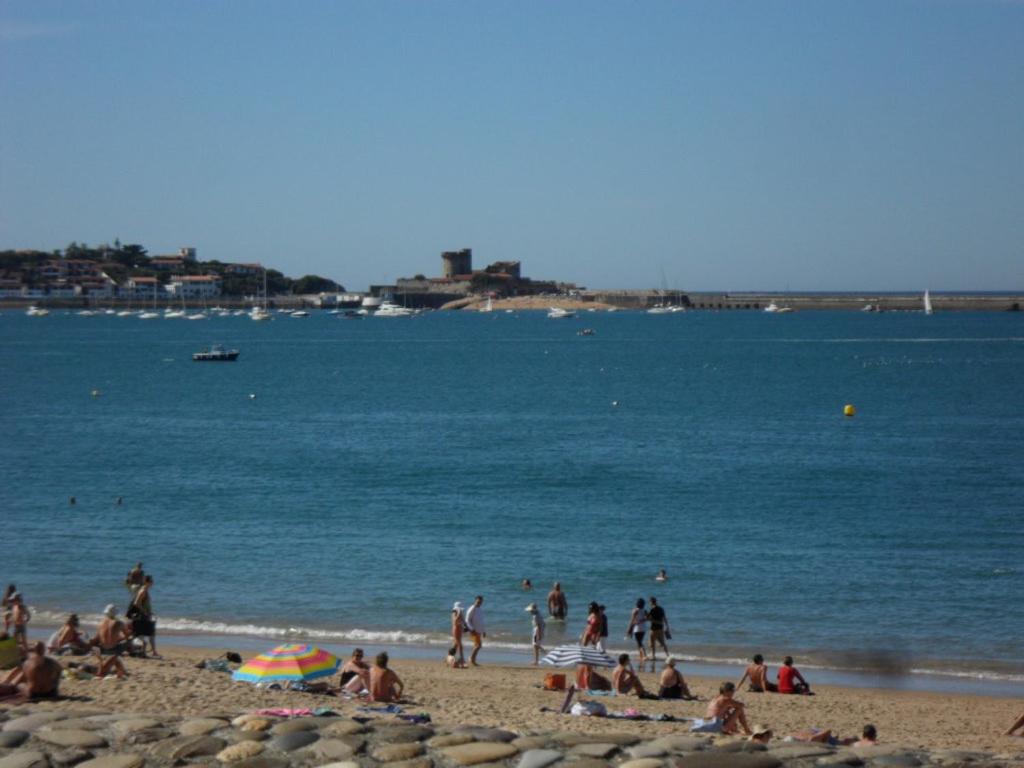 a group of people on a beach near the water at Toki Alai in Saint-Jean-de-Luz