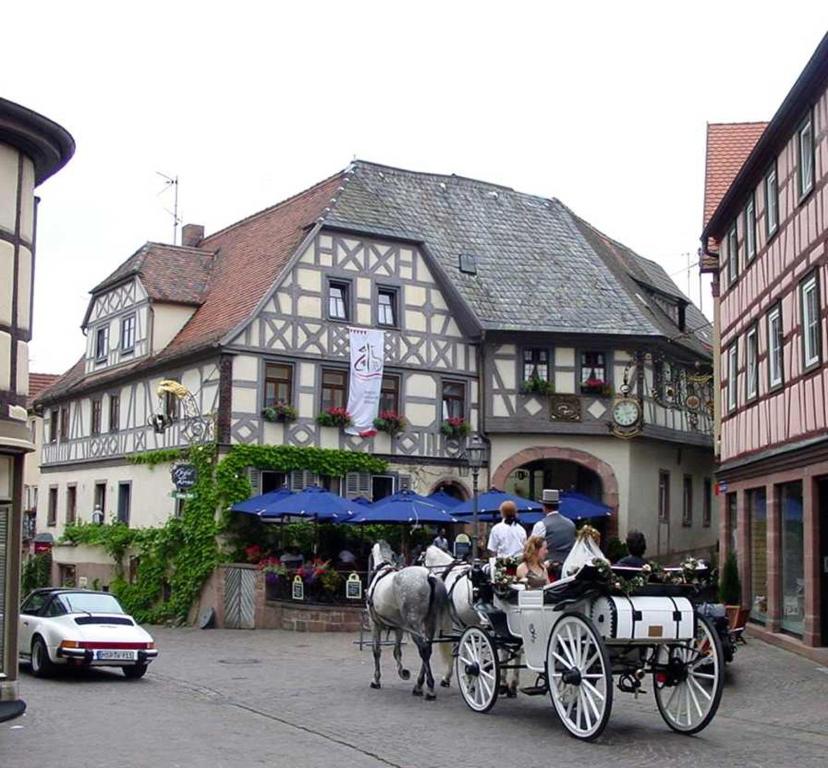 a horse drawn carriage in front of a building at Hotel Gasthof Krone in Lohr am Main