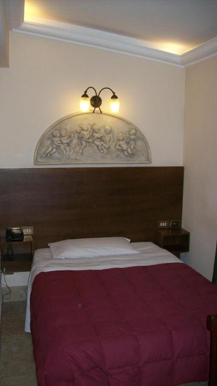Postel nebo postele na pokoji v ubytování Hotel Prati