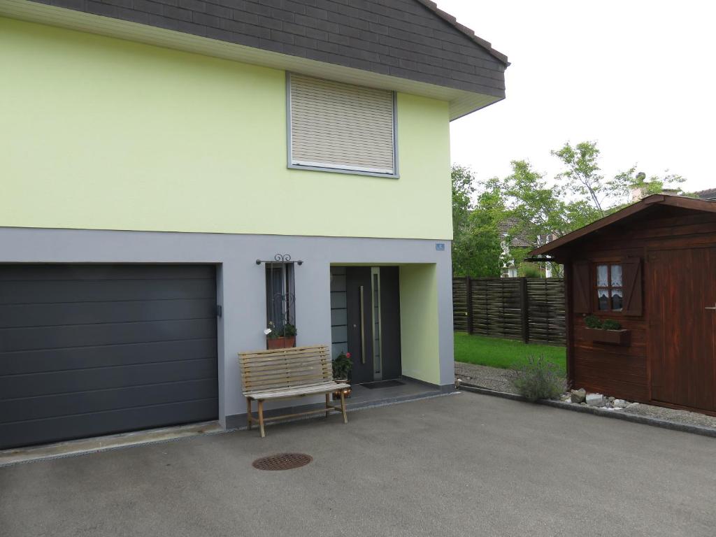 a garage with a bench in front of a house at Studio-Ferienwohnung Hans Fässler in Appenzell