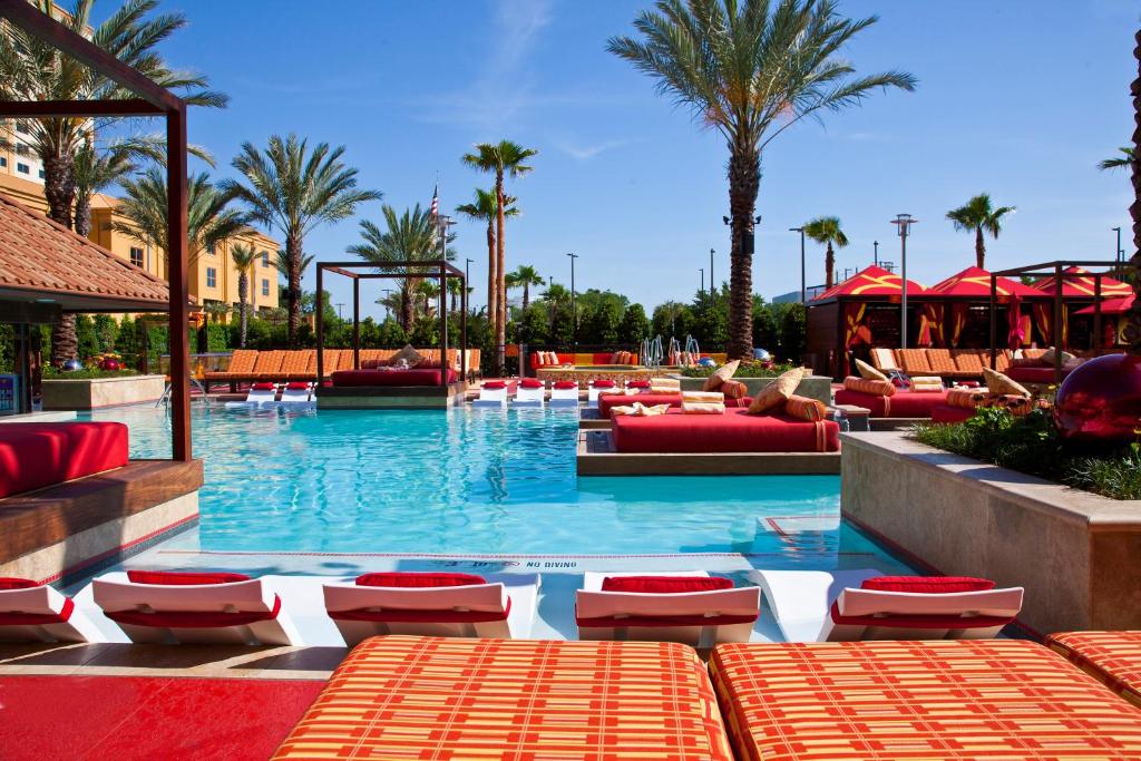 a pool at a resort with chairs and palm trees at Golden Nugget Biloxi in Biloxi