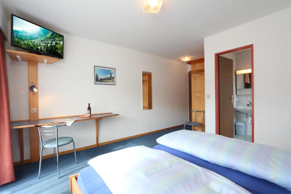 Postel nebo postele na pokoji v ubytování Hotel Garni Domino