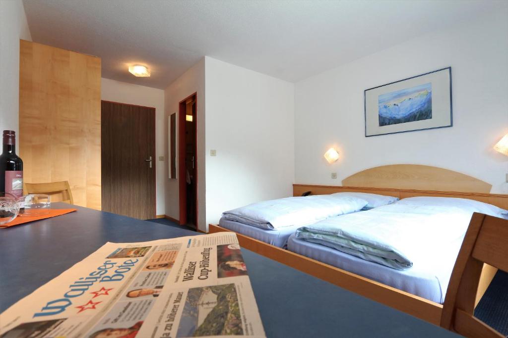Postel nebo postele na pokoji v ubytování Hotel Garni Domino