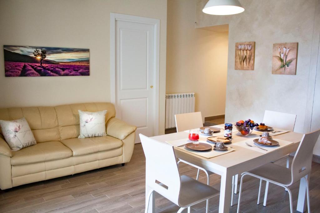 a living room with a table and a couch at Taormina Family Apartment in Taormina