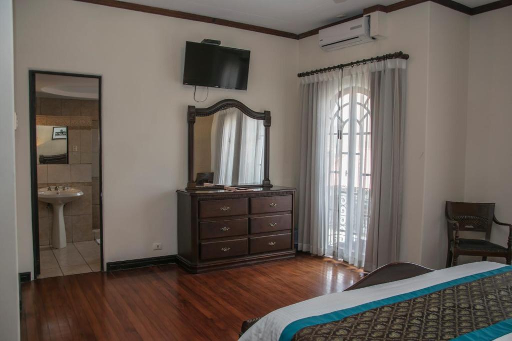 Postel nebo postele na pokoji v ubytování Hotel Colonial