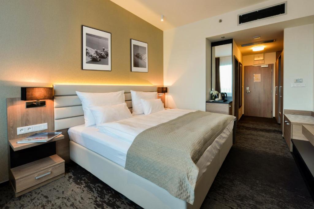 Postel nebo postele na pokoji v ubytování Grid Hotel