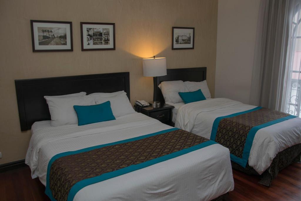 Postel nebo postele na pokoji v ubytování Hotel Colonial
