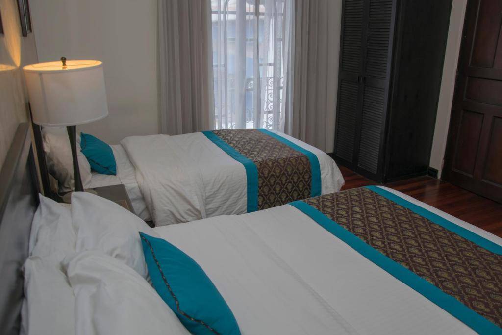 Postel nebo postele na pokoji v ubytování Hotel Colonial