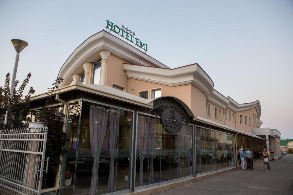 a building with people walking in front of it at Hotel Emi in Strumica