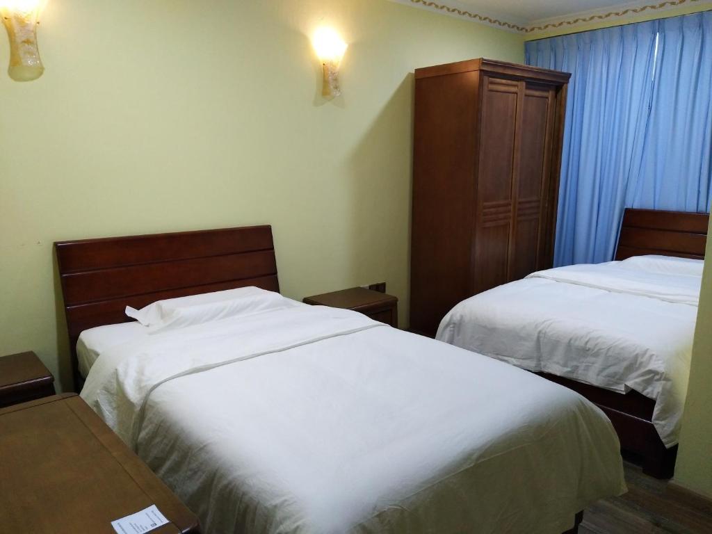 Postel nebo postele na pokoji v ubytování Uncle Ho Motel