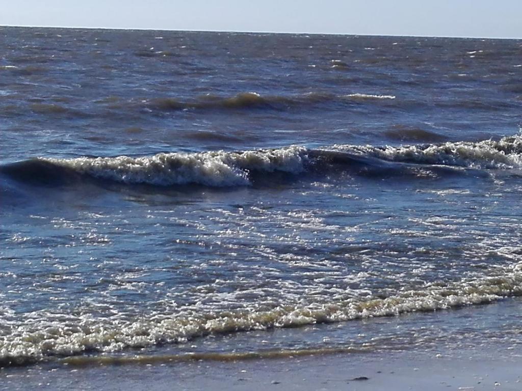 a group of waves in the ocean on a beach at Imantas in Salacgrīva