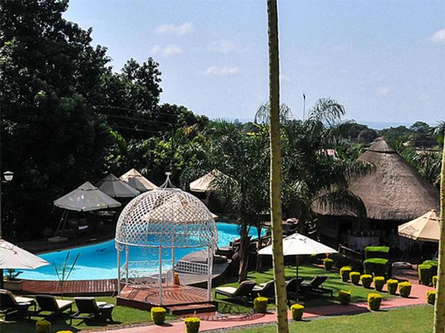 a resort with a swimming pool and a bird cage at 2Ten Hotel in Sibasa