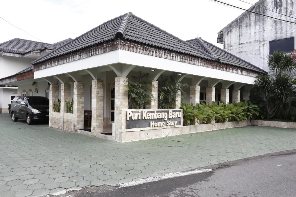 a building with a sign in front of it at RedDoorz Plus near Adisucipto Airport 2 in Yogyakarta