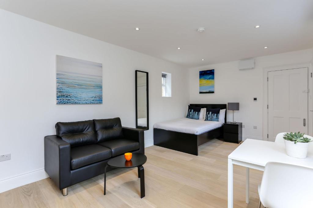 a living room with a couch and a bed at Kings Cross Serviced Apartments by Concept Apartments in London