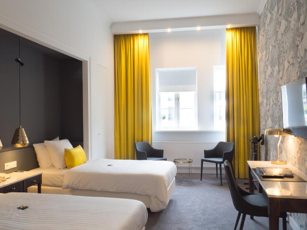 Postel nebo postele na pokoji v ubytování Van der Valk Hotel Hildesheim