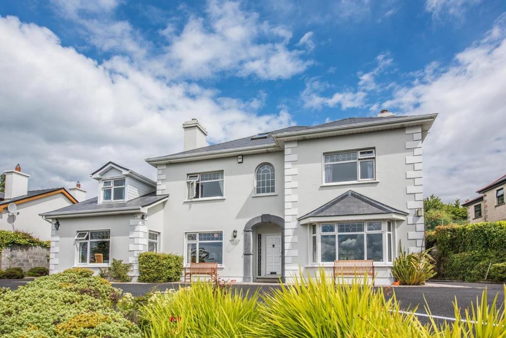 a white house with a landscaping at Westport Heights in Westport