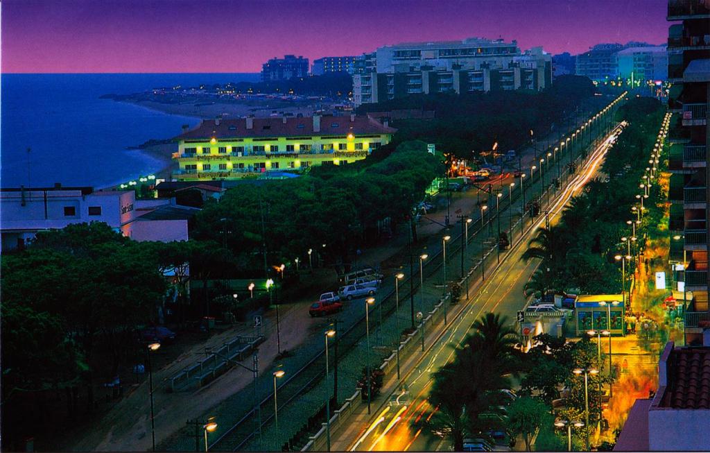 a city street with street lights at night at Apartamentos Quintasol in Malgrat de Mar