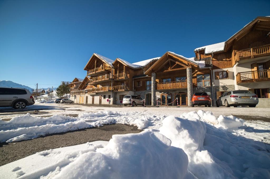 a pile of snow in front of a lodge at Noemys Chalets du Hameau des Aiguilles in Albiez-Montrond