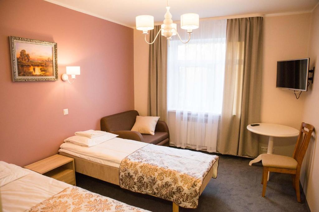 Postel nebo postele na pokoji v ubytování Ankur Hotell