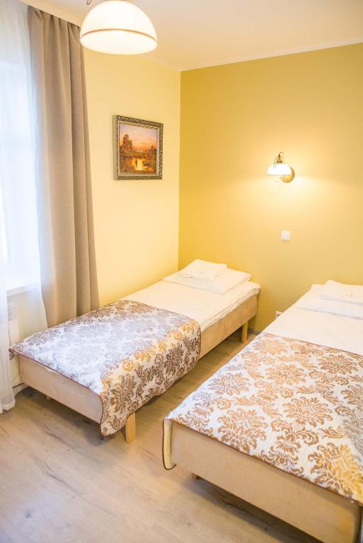 Postel nebo postele na pokoji v ubytování Ankur Hotell