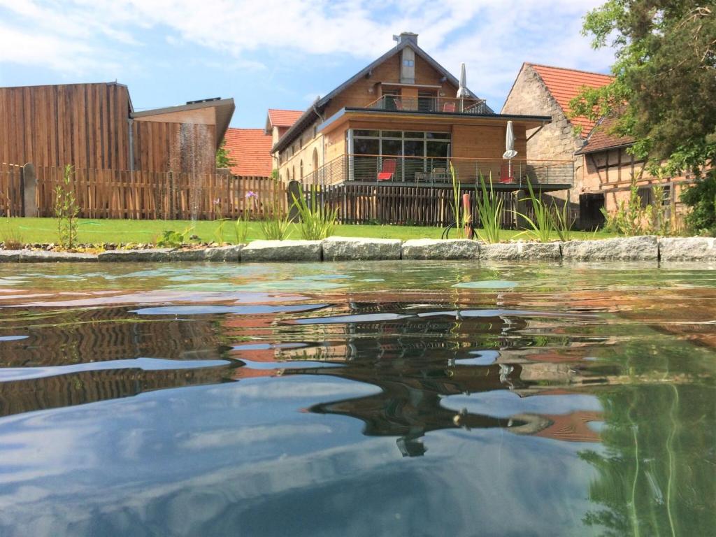 a house with a pond in front of it at Brauhaus 3 - Adults only in Königsberg in Bayern