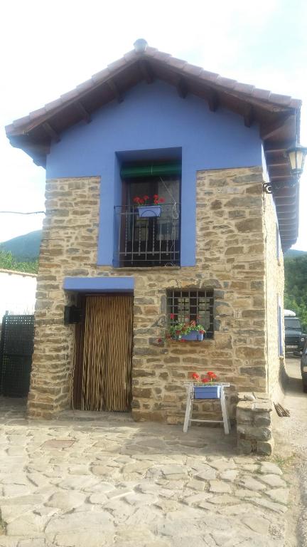 a blue building with a table in front of it at La Casa Azul in Yosa de Sobremonte