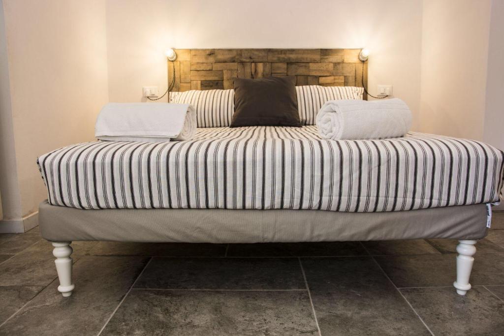a large bed with two pillows on top of it at Apartment Sotto Il Santo in Orco Feglino