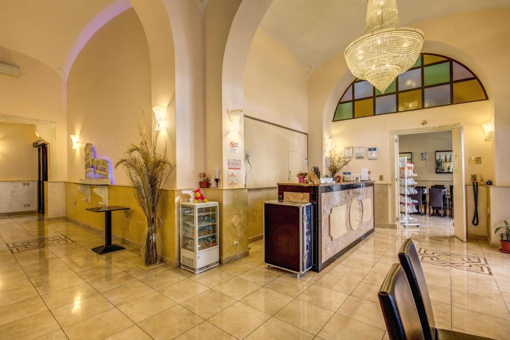 a lobby with a table and chairs in a building at Hotel Maryelen in Rome