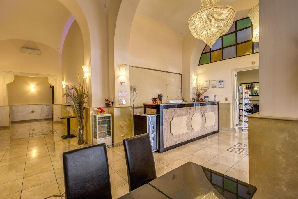 a large kitchen with a table and chairs in a room at Hotel Maryelen 2 in Rome