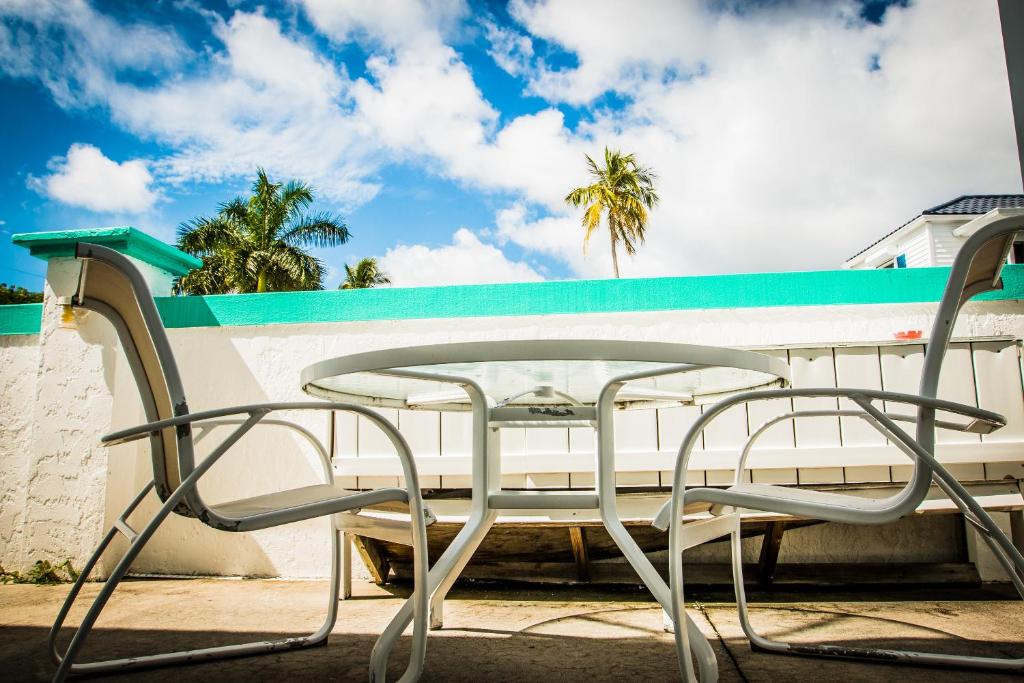 a table and chairs sitting next to a bench at The BoatHouse in Marco Island