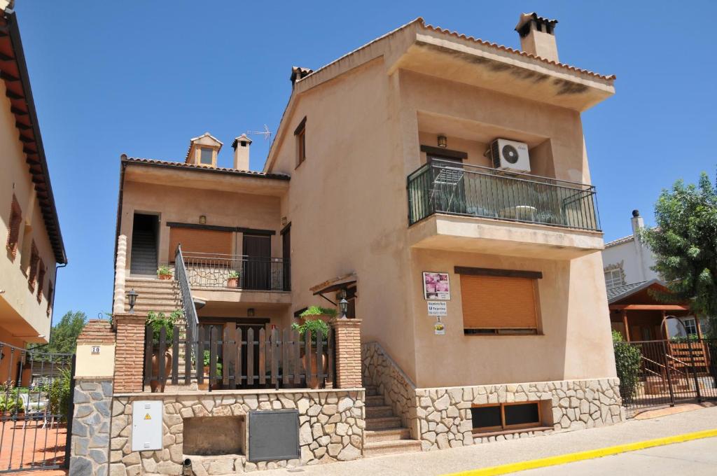 a large house with a balcony on a street at Alojamientos Rural Tejerina in Arroyo Frio