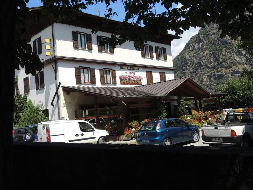 a building with cars parked in front of it at Albergo Bar Brenve in Issogne