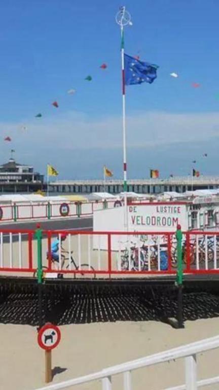 a red and white boat with a flag on it at apartment Seaside in Blankenberge