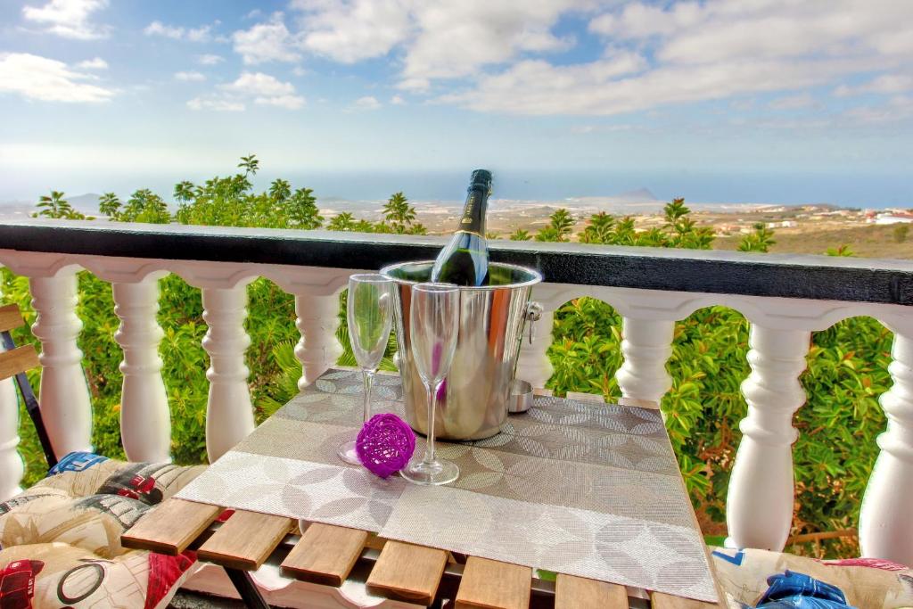 a table with a bottle of wine on a balcony at Marody House Vacacional in Granadilla de Abona