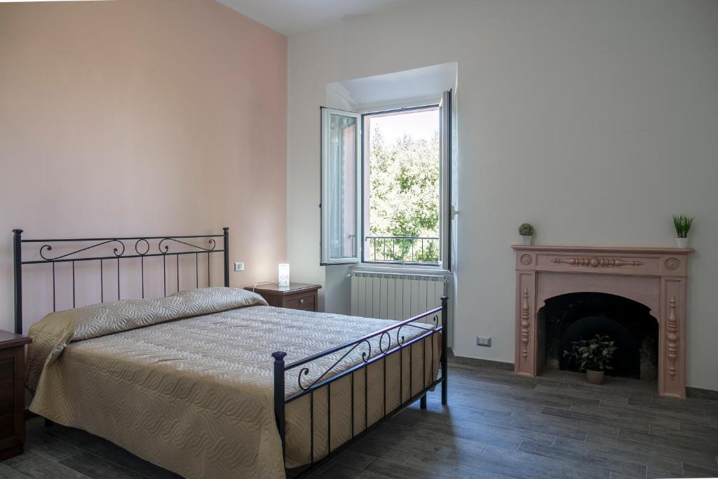 a bedroom with a bed and a fireplace at La Sosta B&B in Stroncone